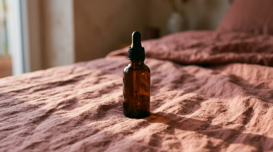A dark amber dropper bottle in low evening light casting a long shadow, representing night-time retinol use